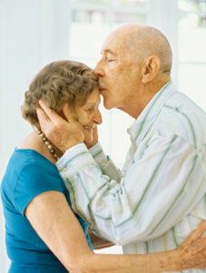 Side view of a senior man kissing a senior woman's forehead