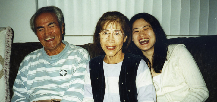long distance caregiver Emi Gusukuma and her parents Yuki and Gus sitting on the couch