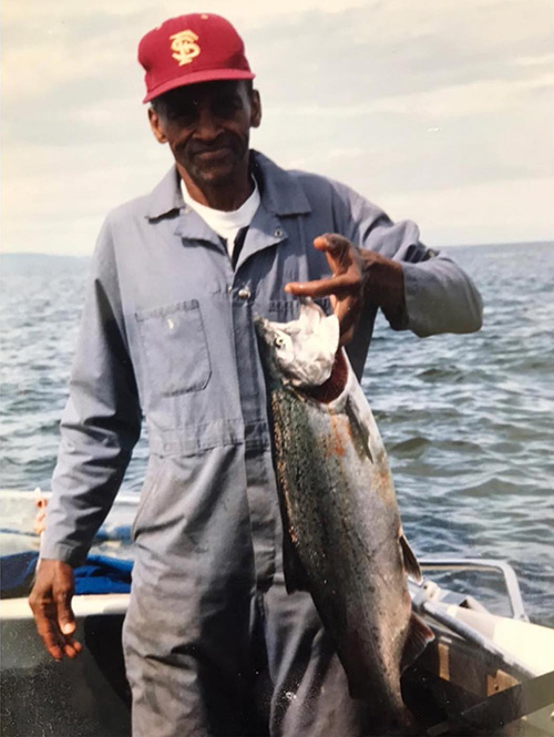 Howard holds the fish he just caught