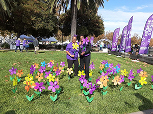 Teri poses with a yellow flower, honoring her grandma, Rachel, at the Solano County Walk to End Alzheimer's