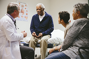 Doctor talking with a patient and his caregivers