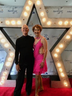 Volunteer co-chairs Nancy and Bart pose in their dance costumes for The Longest Day