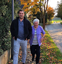 Volunteer Ben walks with his Oma who has Alzheimer's