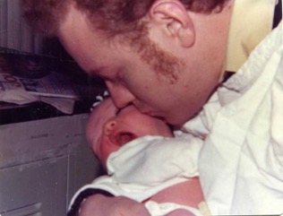 Bruce Pasternack kisses his new baby Joanne 