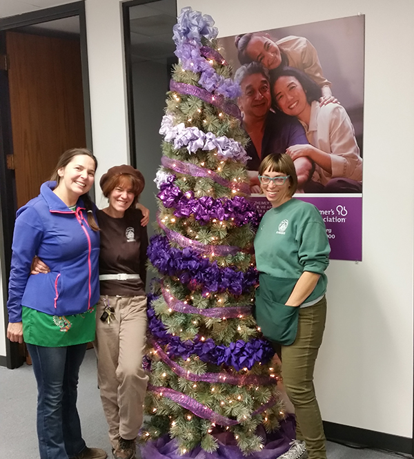 Lori Ann stands in front of the Christmas tree she donates to the Alzheimer's Association