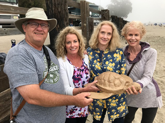 Sarah and her siblings hold the turtle urn they bought for their mom who died with Alzheimer's