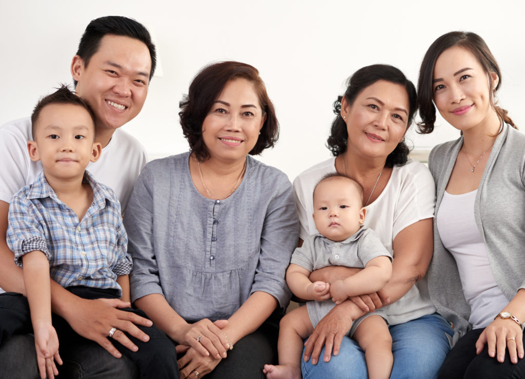 Asian family smiling at camera