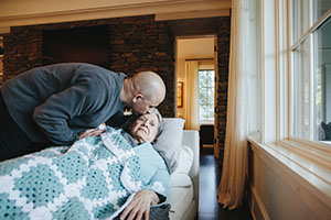 Woman with Alzheimer's being kissed by son 