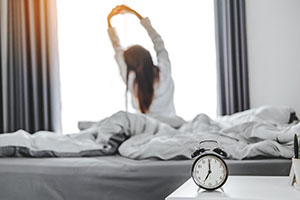 Woman stretching as she wakes up 