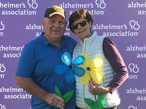 Wally and Pat hold promise flowers at Walk to End Alzheimer's