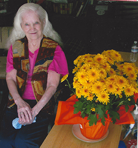 Margie, who had Alzheimer's, posing with some flowers