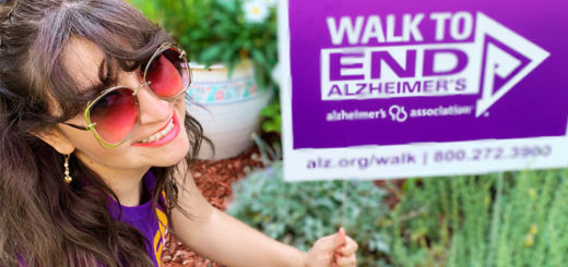 Barbara poses with her Walk to End Alzheimer's yard sign