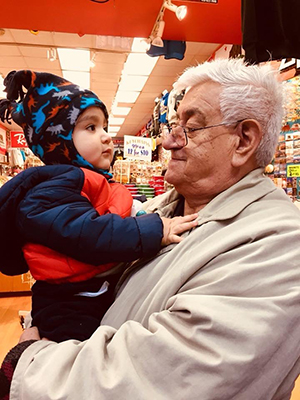 Lizandro who has dementia, holds his 3 year old grandson