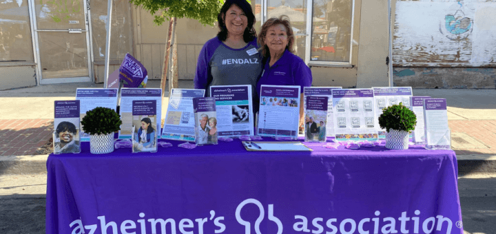 Hortencia and staff behind Alzheimer's Association resource table