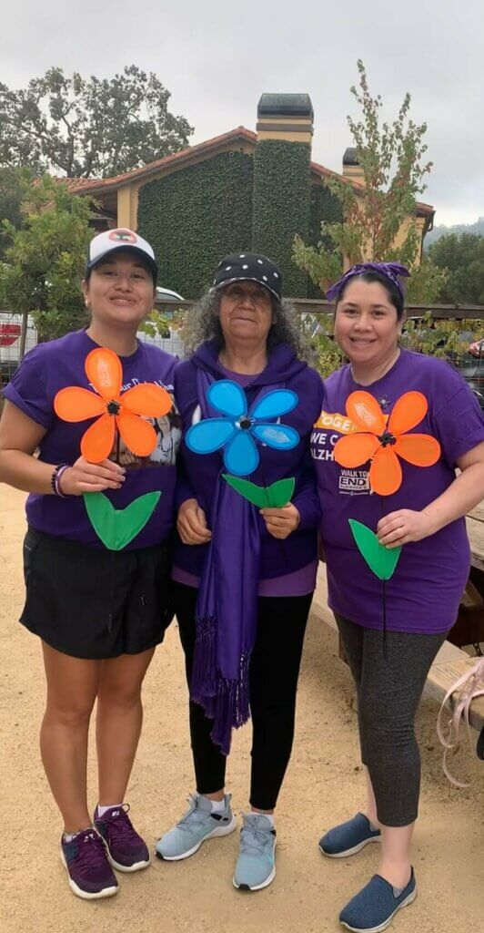 Sandra, Maria and Blanca at Walk, holding promise flowers