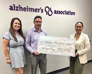 Kate from Arthur Murray presents a check to the Alzheimer's Association for The Longest Day