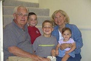 Sharon, who had dementia, poses with her husband and grandkids