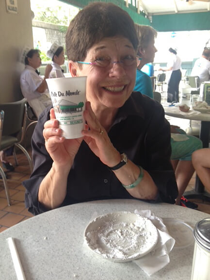 Elaine who is living with Alzheimer's holding coffee