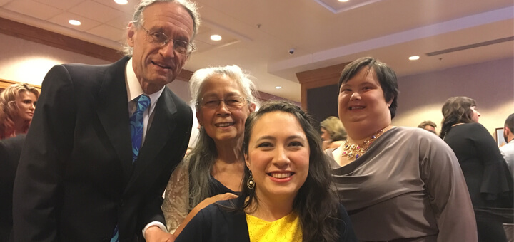 Lili, Olivia, who has Down syndrome and their family at a party